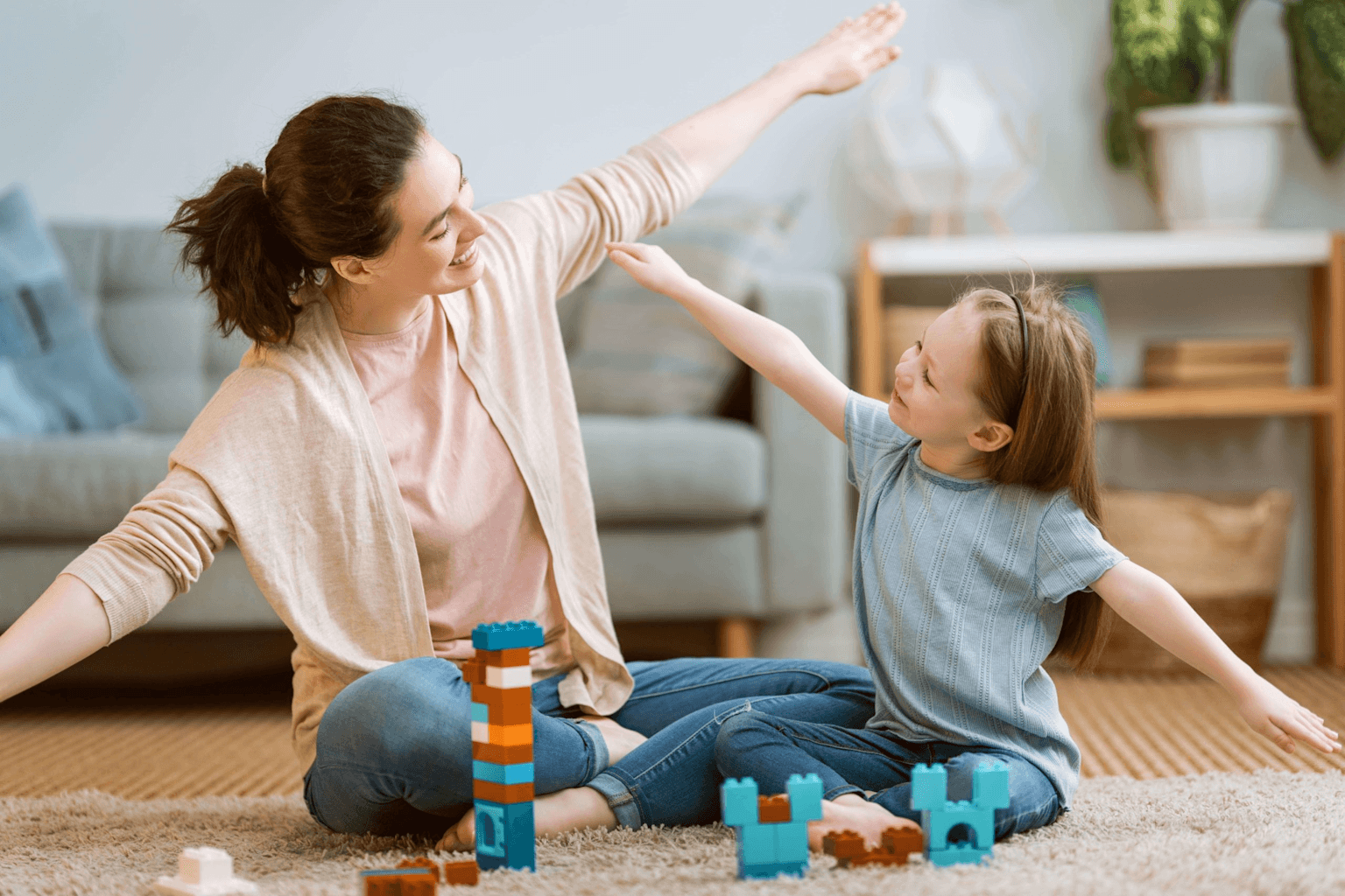 Adult and child engaging in floor-based interactive play typical of DIR/Floortime therapy.