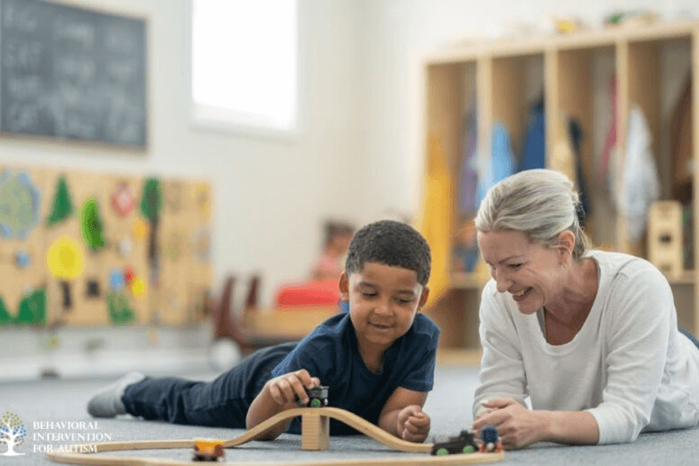 Child and adult engaged in play therapy using a wooden train set, illustrating early intervention for autism.